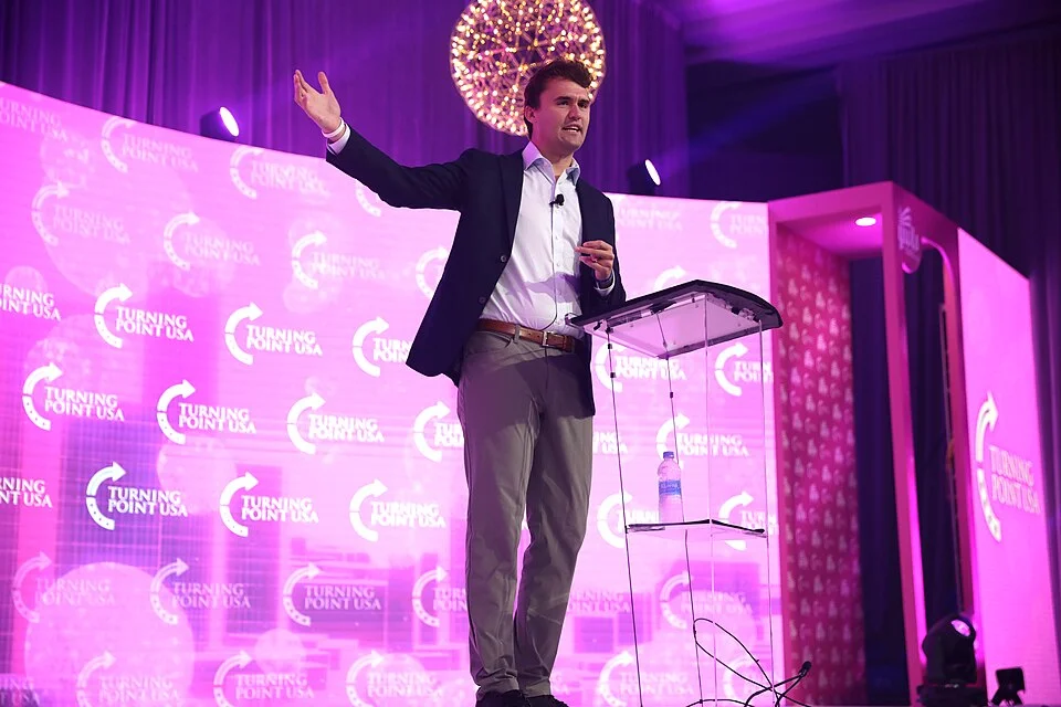 Charlie Kirk speaking at a Turning Point USA event podium
